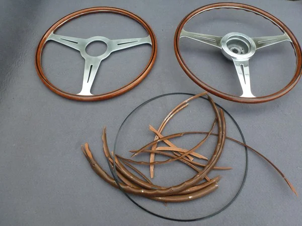 Alfa Romeo 2600 Nardi restored steering wheel next to replica and original wood remains