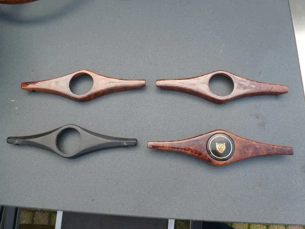 Jaguar MK2 original horn cover shown next to wooden recreations