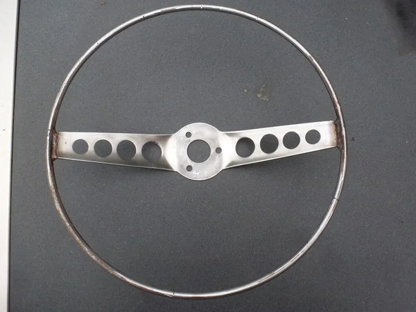 Volvo P1800 steering wheel with original plastic removed during restoration
